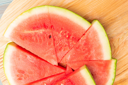 Tasty sliced watermelon on table. Slices of watermelons on cutting board