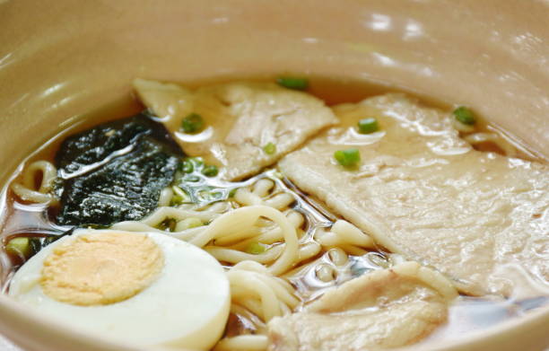 shoyu ramen or Japanese yellow noodles topping slice braised pork and boiled egg  in soy sauce soup