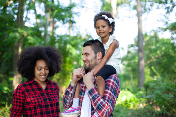 istock Happy family walking along a path in the woods 1492609335