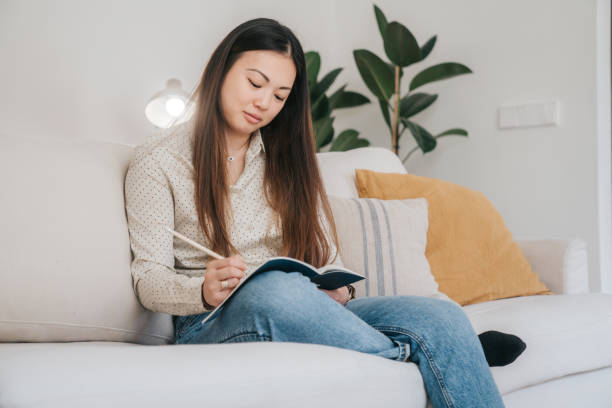 istock Young woman journaling 1492609796