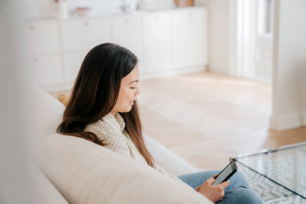 istock Woman using smart phone at home 1492609817
