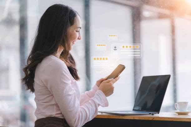 istock A customer hands pressing on a smartphone screen with a gold five-star rating feedback icon.User give rating to service experience on online application. Client review and customer rating concept 1492609861