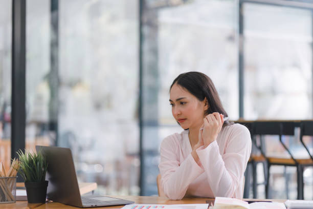 istock Professional millennial Accountant Woman in casuals working on financial analysis documents with a tense expression in the office. 1492609883