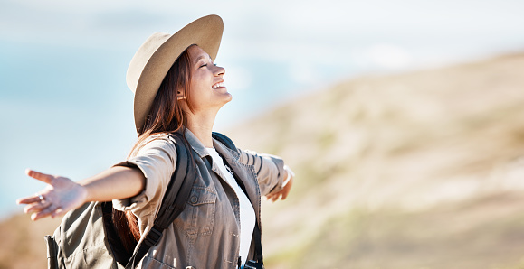 Woman, tourist and smile for travel freedom, hiking adventure or backpacking journey on mountain in nature. Female hiker smiling with open arms enjoying fresh air, trekking or scenery on mockup