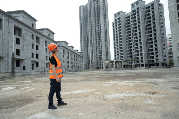 una ingeniera trabaja en un sitio de construcción usando una tableta - blueprint construction worker real estate new fotografías e imágenes de stock