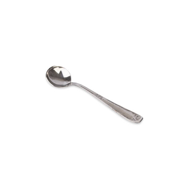 istock Old decorated metal dessert spoon isolated over white background 1492612388