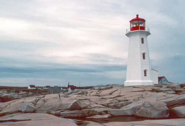 istock Peggy's Cove Lighthouse & Distant Village - 1994 1492612438