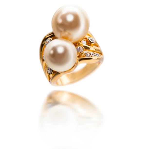 istock Closed up white pearl with diamond and gold ring isolated on white 1492613266