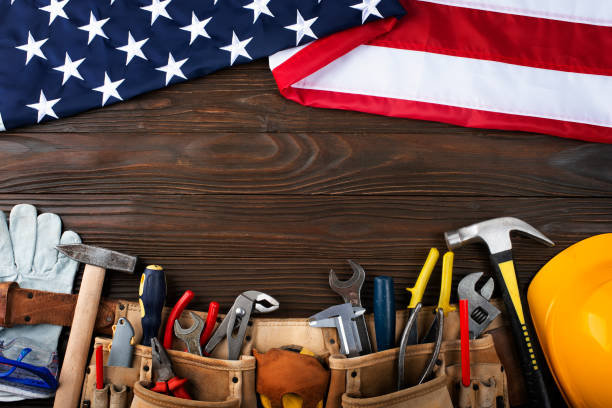 istock Tools hardhat toolbelt and us flag on wooden background labor day banner mockup 1492617371