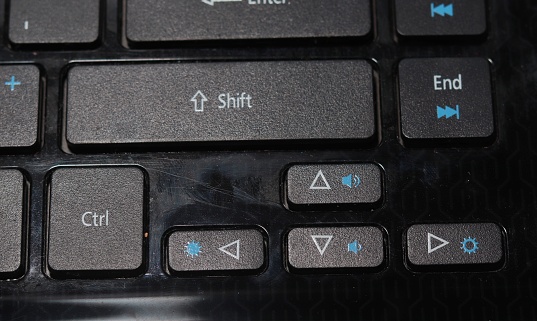 Fingers pressing keys on a laptop keyboard