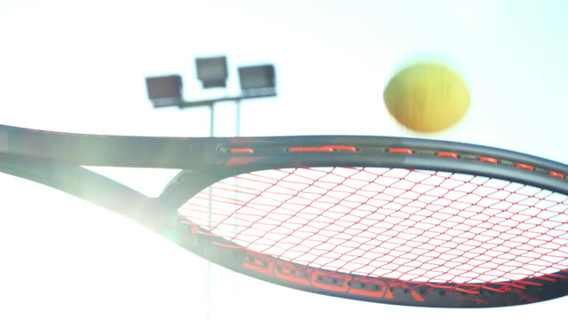 Close up tennis ball bouncing on a racket