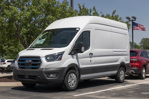 Fishers - Circa May 2023: Ford E-Transit Cargo Van display at a dealership. Ford offers the E-Transit in Cargo Van, Chassis Cab or Cutaway models.