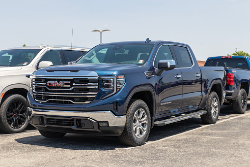 Fishers - Circa May 2023: GMC Sierra 1500 pickup display at a dealership. GMC offers the Sierra in HD, HD Pro, AT4 and Denali models.