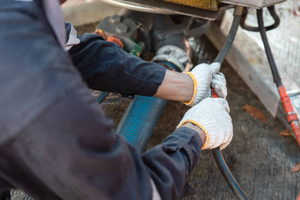 Connecting to hydraulic hose line. The technician worker is connecting the hydualic line with skimmer unit, the oil spill recovery machine. Industrial working action photo. selective focus. hydraulic platform stock pictures, royalty-free photos & images