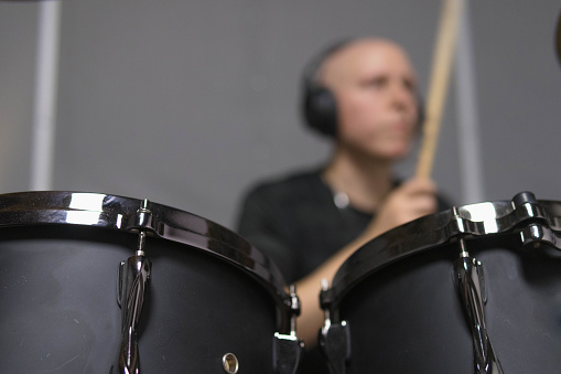 a defocused shot of a drummer playing his instrument