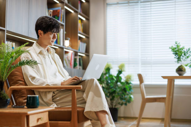 Young white-collar workers work with laptops in the living room