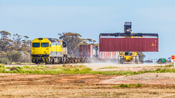 istock Loading freight train with containerised agricultural products in dusty rural terminal in northern Victoria 1492627120