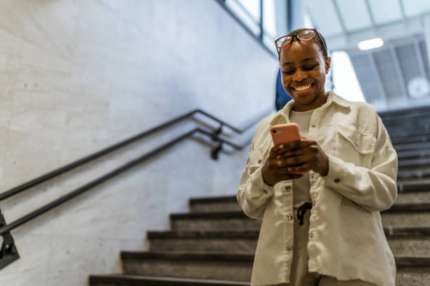 istock Girl using mobile. Young black woman using mobile in the subway. 1492628955