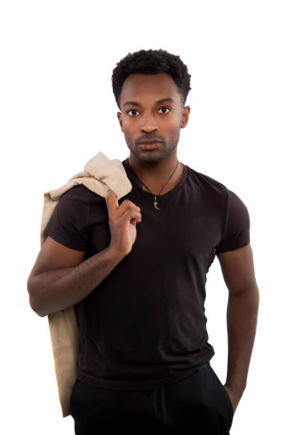man holding jacket over shoulder young businessman studio portrait isolated on white background black t-shirt