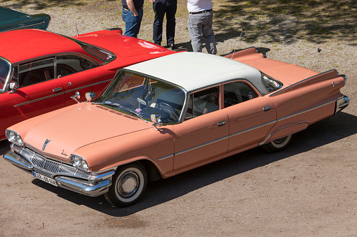 Stade, Germany – May 13, 2023: High angle view of an apricot Dodge Dart Seneca four-door sedan from 1960 at  Spring Fling, an annual meeting of Vintage Chrysler Motor Company car owners.,