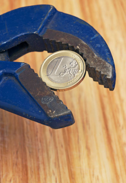 wrench and coin stock photo
