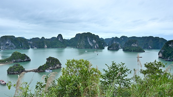 Ha Long Bay is located in Ha Long City, Quang Ning Province, Vietnam. It is a typical limestone karst landform bay. The whole bay has about 120 kilometers of coastline, a total area of about 1553 square kilometers, and about 2000 islets.\nAbout 434 square kilometers of the central area (containing 775 islets) is a World Natural Heritage Site. The scenery is beautiful and charming.\nIt is a national scenic spot in Vietnam. Countless foreign tourists come here for sightseeing.\nThe photos were taken from the top of an island in Ha Long Bay.