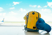 Yellow ruksak with cap and headphones in airport. Travel concept. Travel touristic concept. travel light