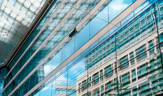 modern office building in glass and and the reflection in the walls