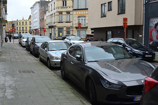 Blankenberge, West-Flanders, Belgium - May 22, 2023: gray color stationary luxury  Italian status car Maserati Ghibli parked in a row in the street