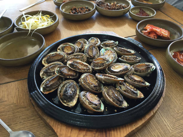 Gourmet food grilled roasted seafood and shell fried burn for korean people traveler travel visit and taste eat drinks cuisine in local restaurant at Hueundae Street Food Market in Busan, South Korea