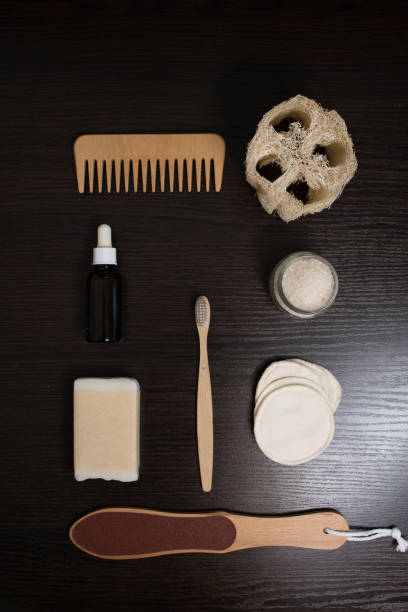 istock Flat lay bath accessories: soap, toothbrush, sponges, emulsion, pumice, comb on black background 1492636664