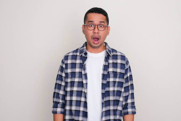 istock Adult Asian standing and showing shocked face expression 1492637460