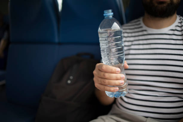 istock Young caucasian man drinking water from plastic transparent bottle 1492638474