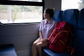 Young woman rides by the window on a train