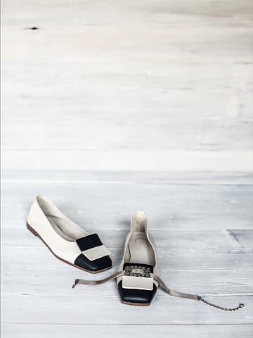 White and Black Woman Ballerinas Shoes on Wooden Background