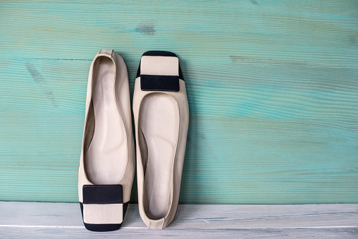 White and Black Woman Ballerinas Shoes on Wooden Background