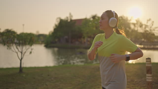 Young Asian woman running exercise at morning