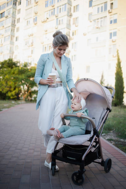 istock Happy mother with stroller in park 1492639657