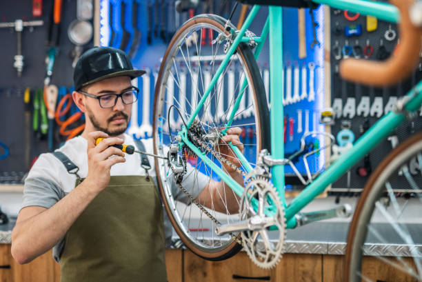 istock Man working in his own bike workshop and fixing bikes. 1492639766