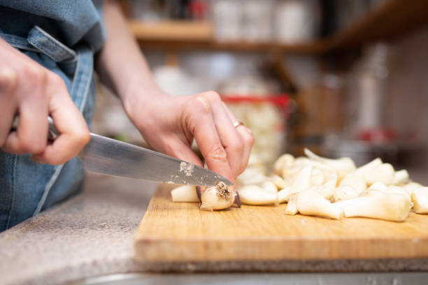 istock A woman's hand cutting a lot of shallots 1492640562