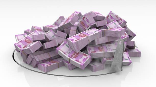 istock Indian banknotes falling through a hole cut on the floor with a saw 1492640897