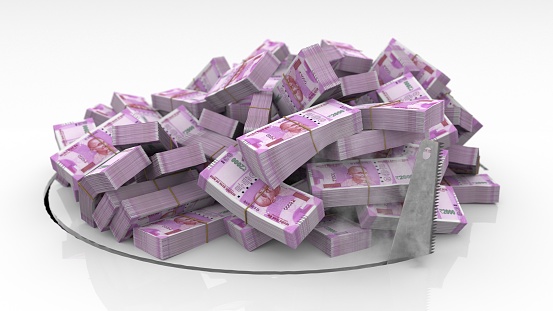 Indian banknotes falling through a hole cut on the floor with a saw
