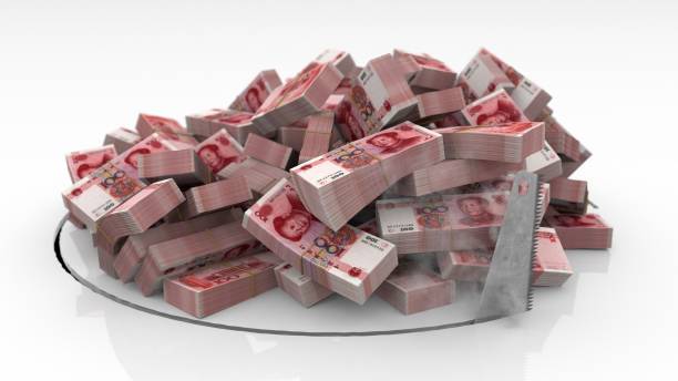 istock Chinese banknotes falling through a hole cut on the floor with a saw 1492640903