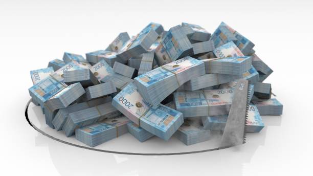 istock Russian banknotes falling through a hole cut on the floor with a saw 1492640904