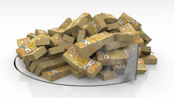 istock Canadian banknotes falling through a hole cut on the floor with a saw 1492640913