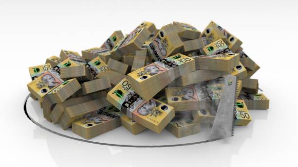 istock Australian banknotes falling through a hole cut on the floor with a saw 1492640914