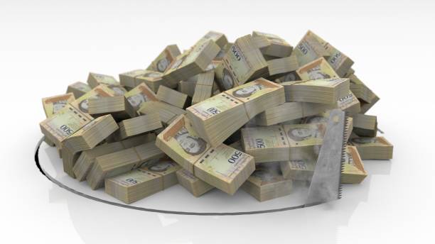 istock Venezuelan banknotes falling through a hole cut on the floor with a saw 1492640916