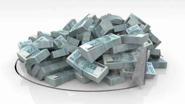 istock Brazilian banknotes falling through a hole cut on the floor with a saw 1492640918