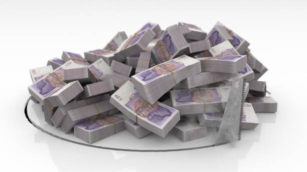 istock British banknotes falling through a hole cut on the floor with a saw 1492640927