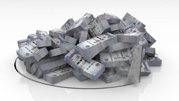 istock Saudi Arabian banknotes falling through a hole cut on the floor with a saw 1492640930